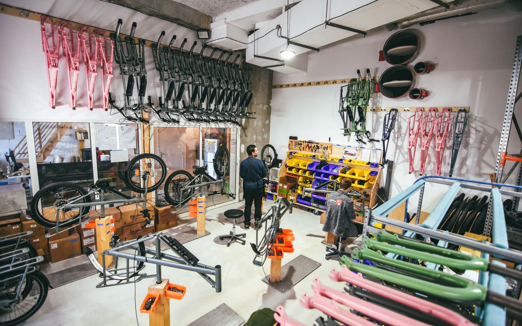 Bike workshop with frames and tools on the wall