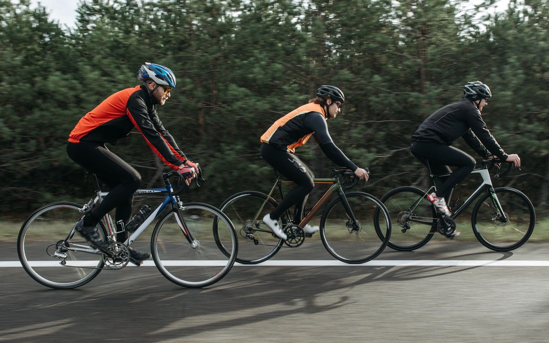Group of cyclists riding together on a road