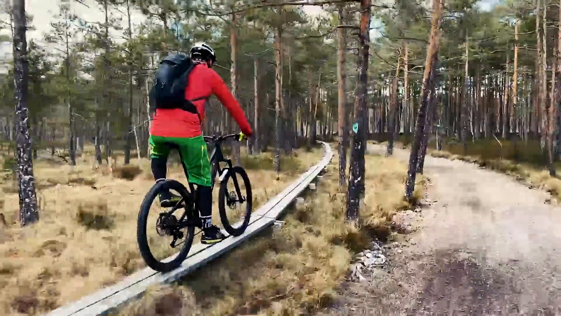 Mountain biker riding a wooden boardwalk trail
